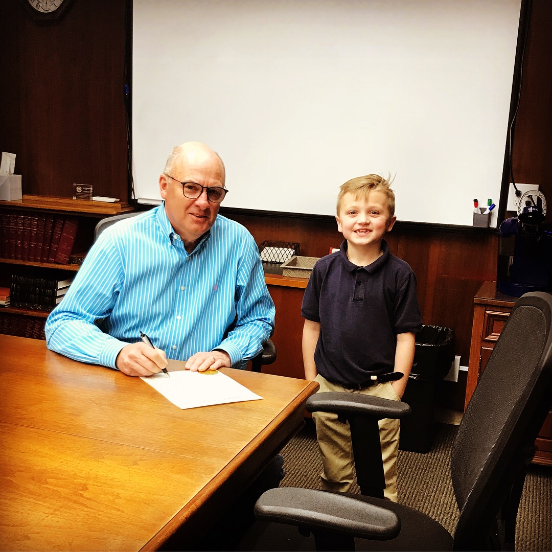 Mayor Bob Coburn and Gray McQueen sign Child Abuse Prevention Month Proclomation